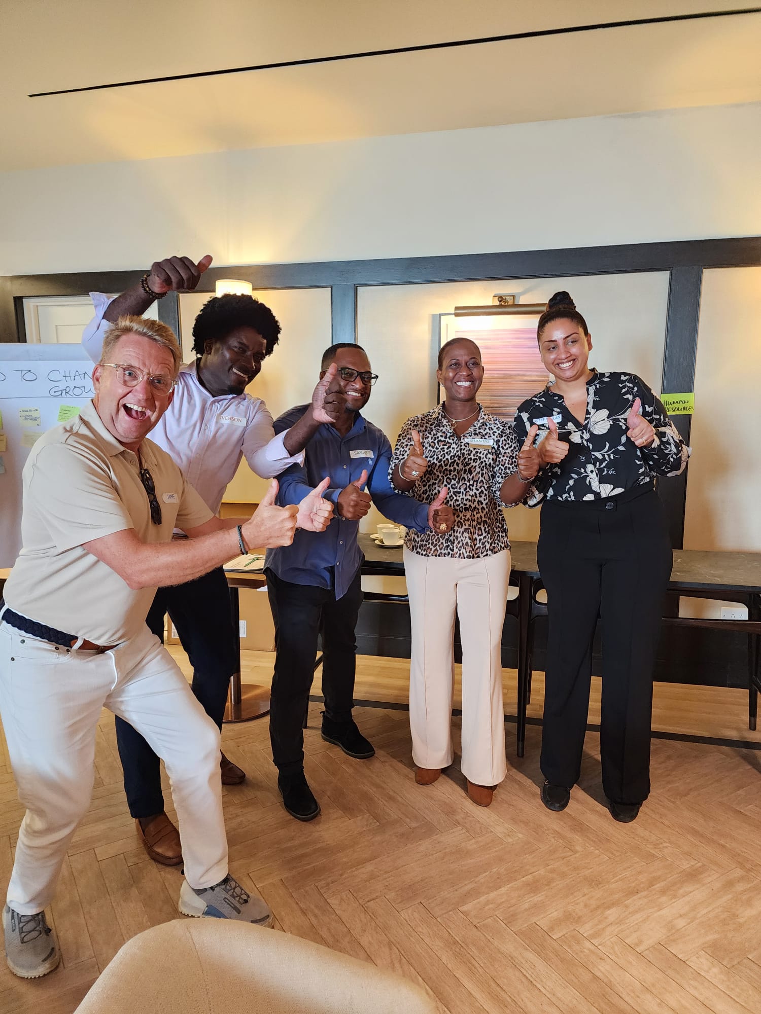 Workshop participants giving thumbs up after completing a session